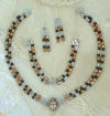 Image of jewlery scarab gold toned pearls and silver motif 
